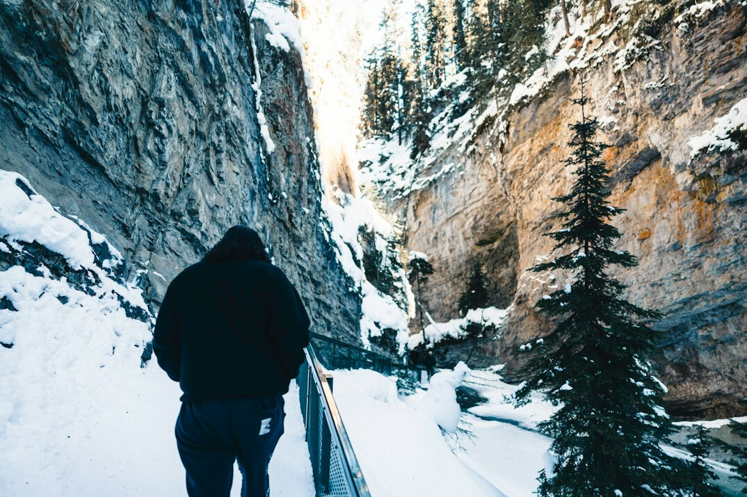 man hiking in snowy mountains